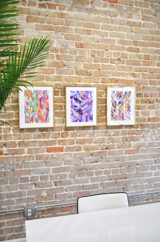 gallery wall of gold picture frames